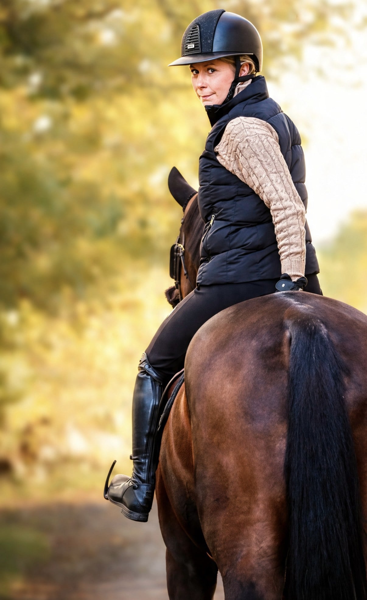 Linda Heed mounted on horseback in evening light